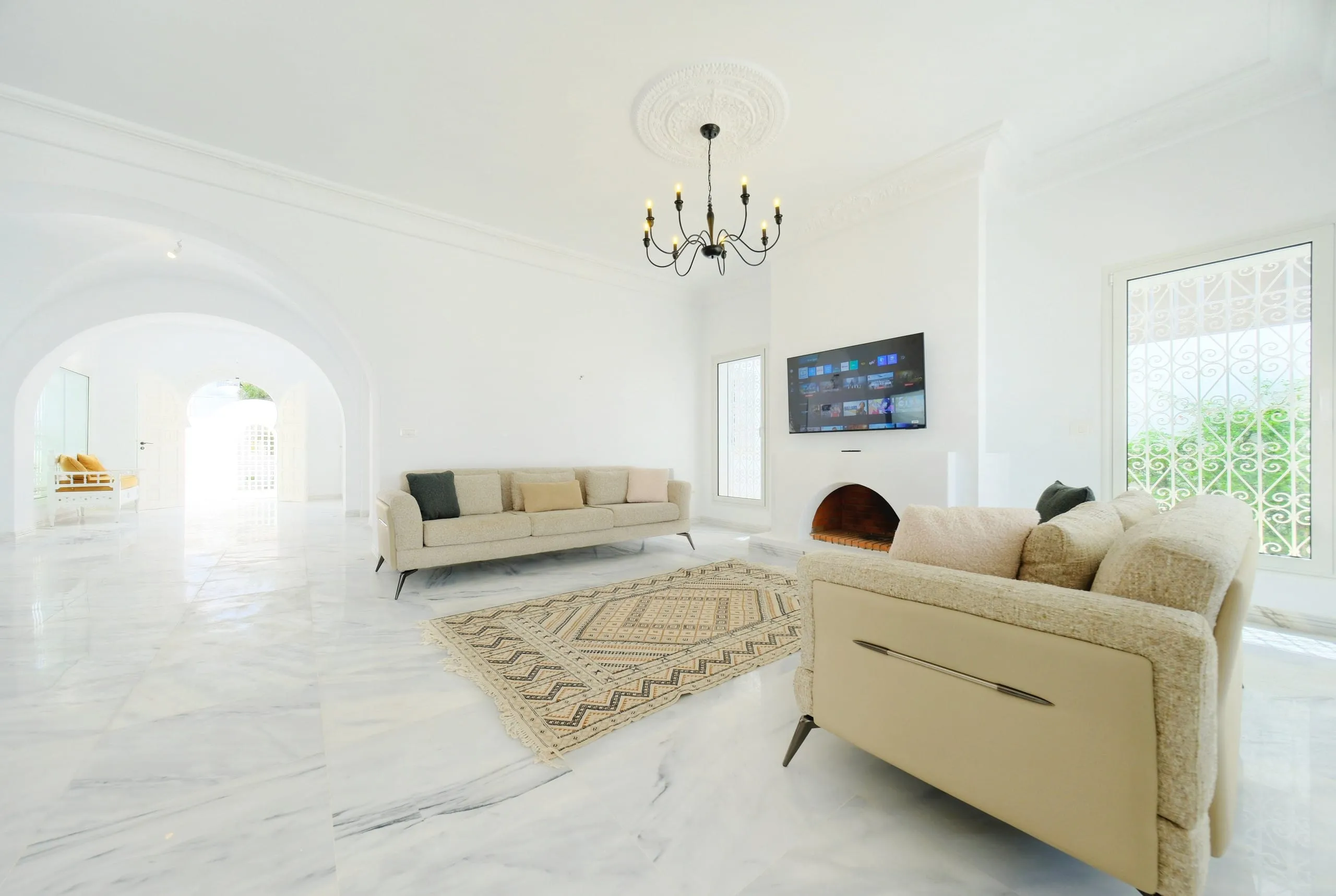 The bright living room with marble floors