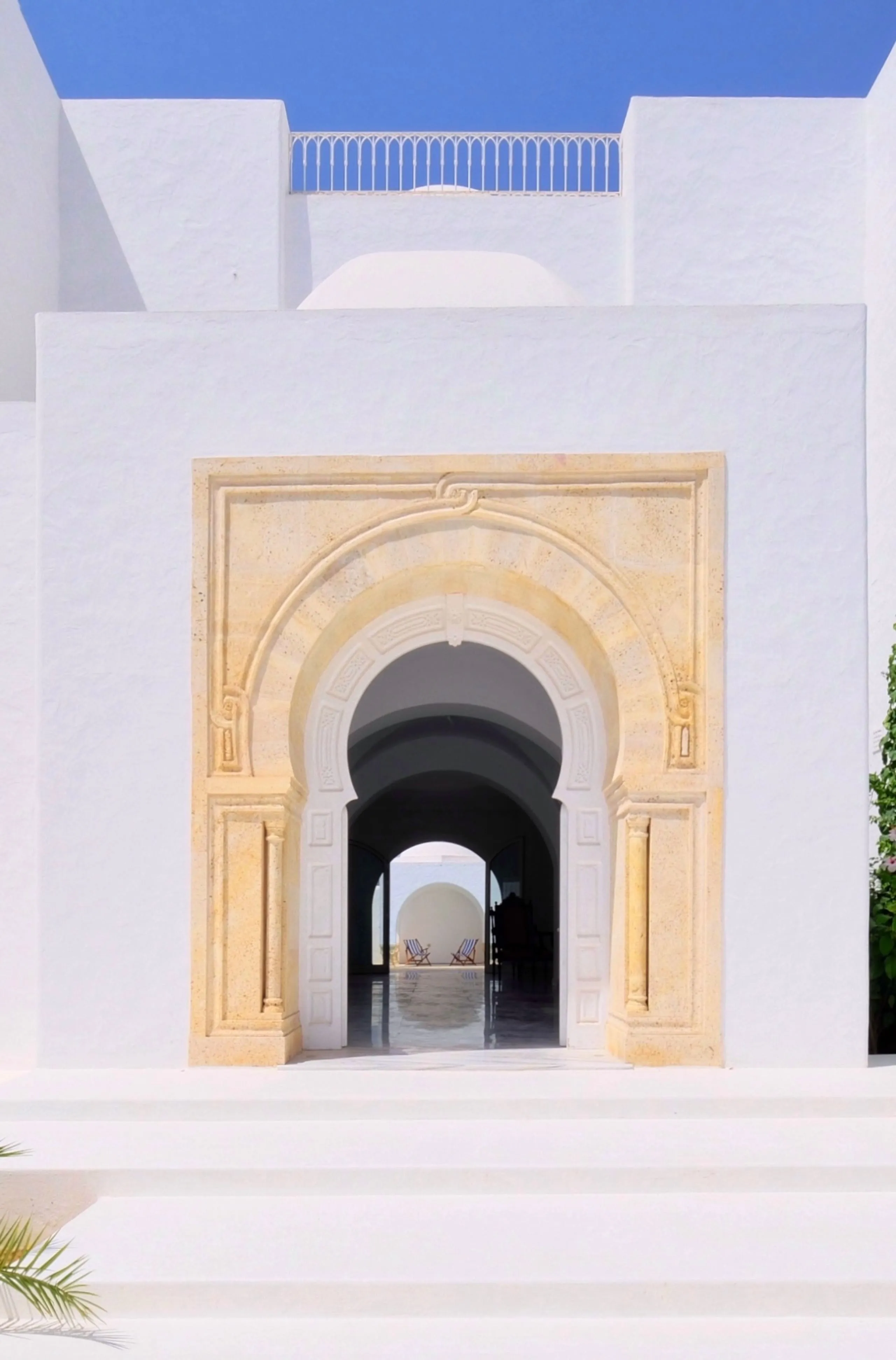 Entrance door framed in carved Dar Chaâbane stone